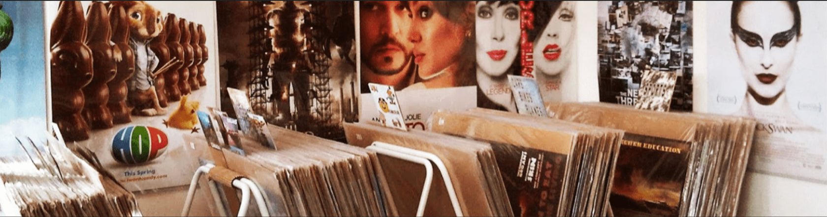 About Us page background image showing a movieposter collection