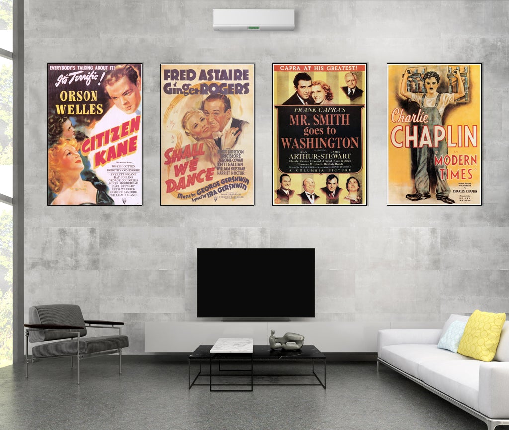 Four posters mounted on plak in a living room setting